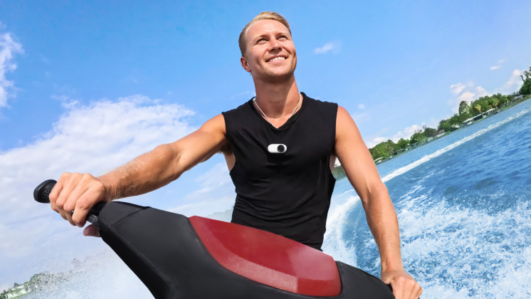 insta360 go 3s mounted on a guy's chest with the magnet pendant while he rides on a jet ski